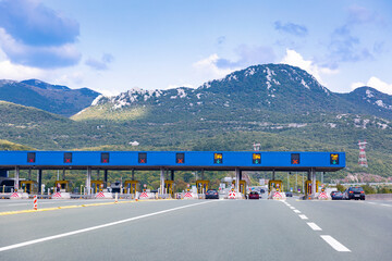 Cars passing on toll road. Point of payment on highway. Beautiful mountain landscape on background. Bitoraj mountains, Gorski Kotar, Croatia. Space for text