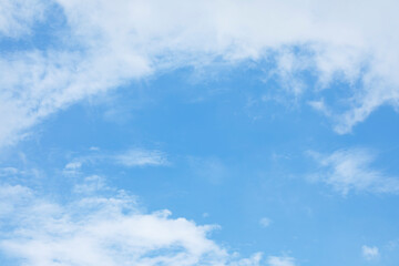Blue sky background and white clouds soft focus, and copy space