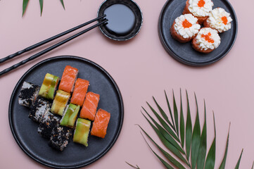 Sushi set on pink background, top view