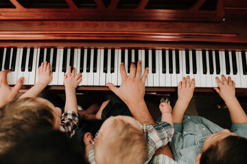 Father and Sons playing piano
