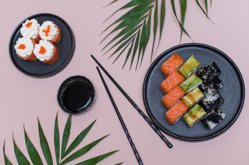 Sushi set on pink background, top view