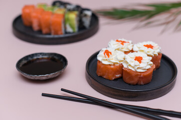 Japanese sushi rolls set with cream cheese on pink background