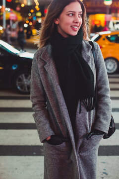 Young woman in New York City at night