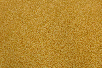 Raw organic couscous grains. Couscous background.