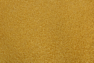 Raw organic couscous grains. Couscous background.