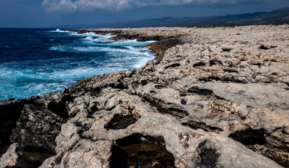 Waves crash on the rocky shore of the Mediterranean Sea on the Akamas Peninsula in the northwest of the island of Cyprus.
