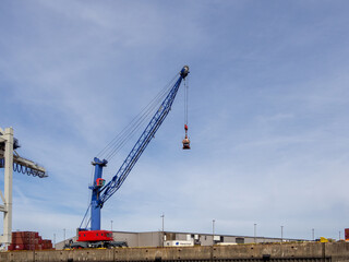 Fototapeta na wymiar a crane for loading and unloading container ships is in the port