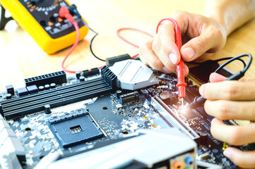 Technicians are repairing computer motherboards in a laboratory with a copy area. Concepts of...