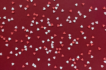 Romantic abstract Valentines Day red backround with plastic white and pink hearts. Love, dating and Valentines Day concept, copy space