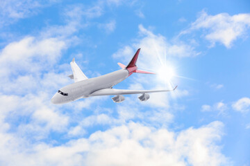 Fototapeta na wymiar Airplane flying in blue sky with clouds. Air transportation