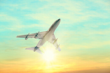 Airplane flying in sky at sunrise. Air transportation
