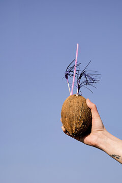 Hand with coconut in the sky