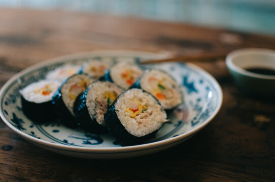 Sushi on the plate on a wooden table
