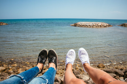 Legs of women on the seashore