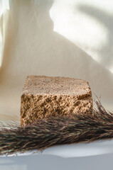 Natural stone cosmetics podium. A podium for cosmetics against a background of shadow from natural...