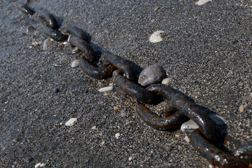 rusty chain on the shore