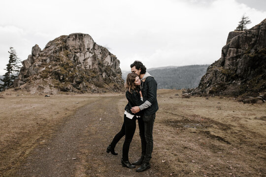 romantic couple embraces in beautiful landscape