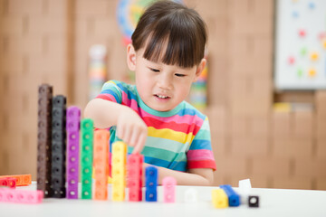  young girl play number blocks for homeschooling
