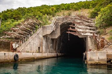 Entrance to abandoned submarine shelter, the Bay of Kotor, the Adriatic Sea, Montenegro. Lustica peninsula Rose village.