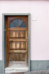 Old wooden door in the stone doorway