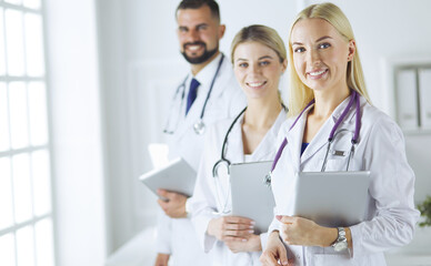Fototapeta premium A medical team of doctors, man and women, isolated on white background