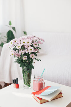 Bouquet of flowers and milkshake on a table