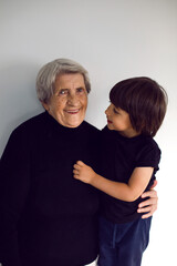 funny grandson in a black t-shirt stands
