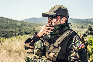 Army special forces soldier, SEALs fighter in camo uniform, shemagh scarf, ballistic glasses and...