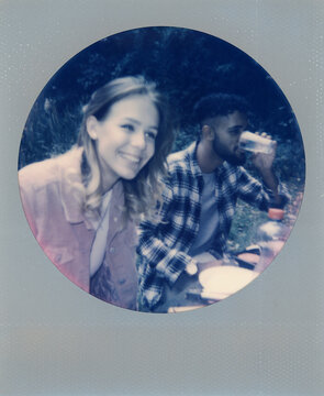 Polaroid print of a couple eating a picnic