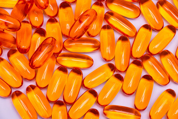 Fish oil supplements colorful orange on white background
