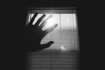 Hand Shielding Light From Window