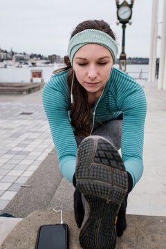 Female athlete stretching outdoor before workout