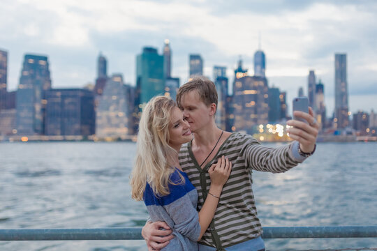 Young Couple Taking Pictures With a Phone in New York City