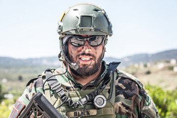 Shoulder portrait of army soldier, special forces fighter, modern warfare combatant with dirty,...