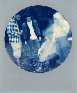 Polaroid print of a group of friends barbecuing