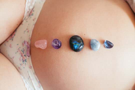 Pregnant woman with healing crystals