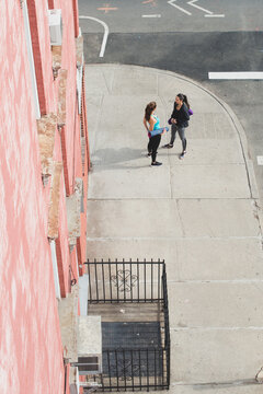 Women on street walking to yoga