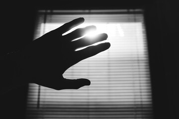 Hand Shielding Light From Window