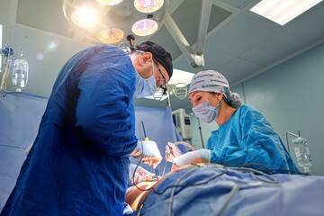 Team surgeon at work in operating room.