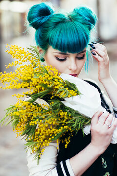 Portrait of a beautiful young woman holding yellow flowers