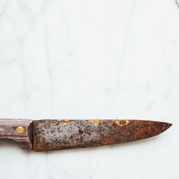 Old knife on a marble top