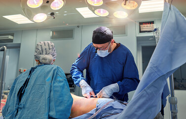 Team surgeon at work in operating room.
