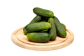 Fresh cucumbers lying on a wooden Board on a white background, isolated.