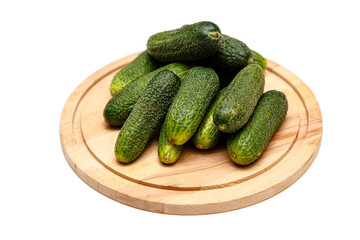 Fresh cucumbers lying on a wooden Board on a white background, isolated.