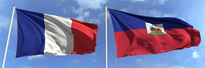 Flying flags of France and Haiti on high flagpoles. 3d rendering