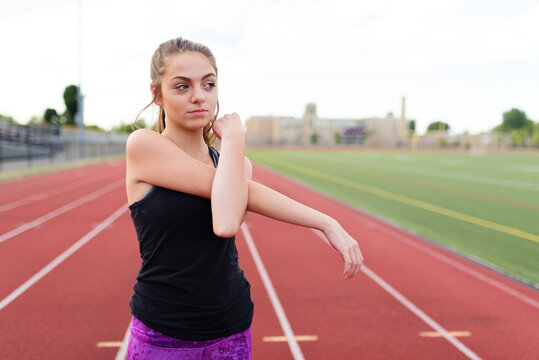A teenage girl working out on her high school ttrack