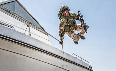 Army commando, special forces soldier equipped with body armour and battle helmet with radio...