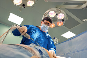 Team surgeon at work in operating room.