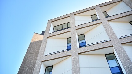 Architectural details of modern apartment building. Modern european residential apartment building complex with sunlight.
