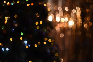 Background texture with bright multicolored glowing lights bokeh on gold and dark green background